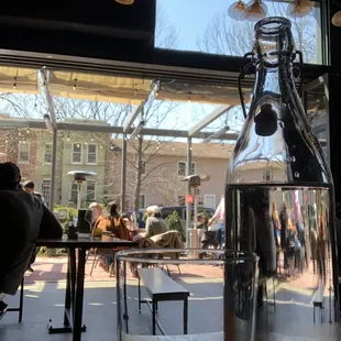 a bottle of water sitting on a table in front of a window