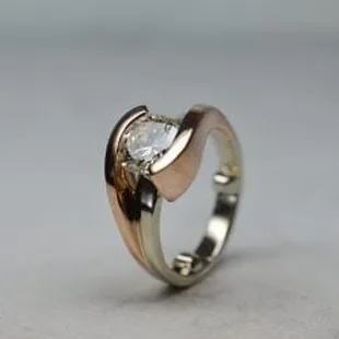 Two tone rose gold and white gold round diamond engagement ring.