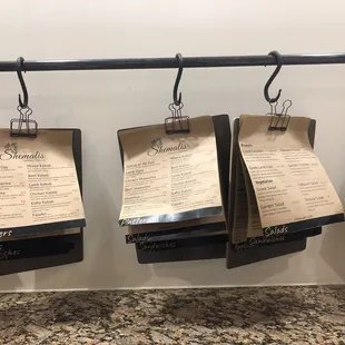 Menus on clipboards hanging by binder clips ...
