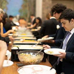 a man in a suit serving food