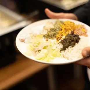 a person holding a plate of food