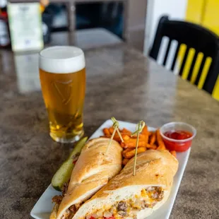 a sandwich and a glass of beer