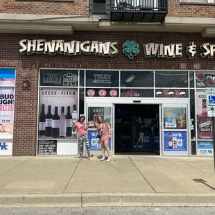 two women standing in front of a store