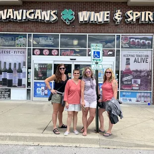 three women standing in front of a store
