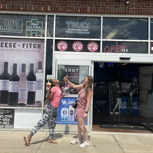 two women in front of a store