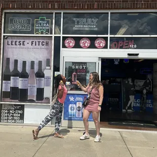 two women in front of a store
