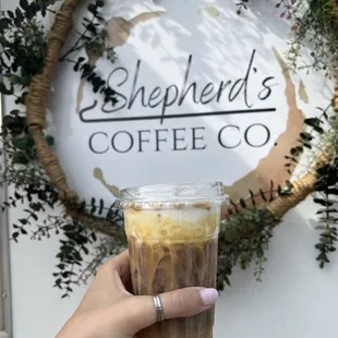 a hand holding a cup of coffee