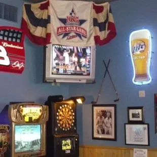 a beer, pinball, darts, darts, and other memorabilia