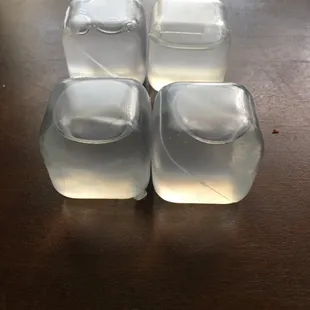 four ice cubes on a table