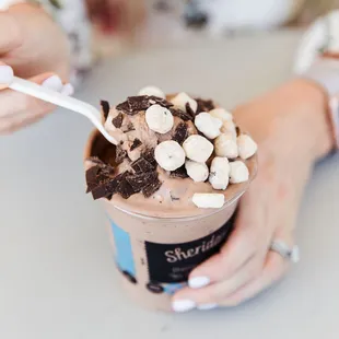 a woman holding a cup of ice cream