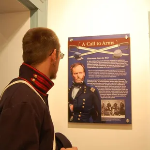 A Civil War reenactor views one of the new story panels.