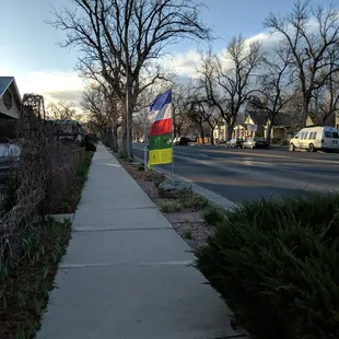 a colorful flag on a sidewalk