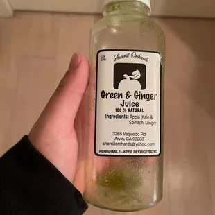a bottle of green and orange juice