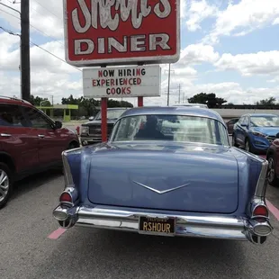a classic car parked in a parking lot