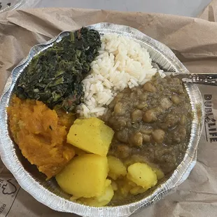 Rice bowl with spinach, pumpkin, potatoes, and chickpea chana masala.