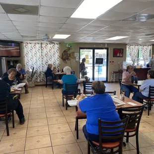 people sitting at tables in a restaurant