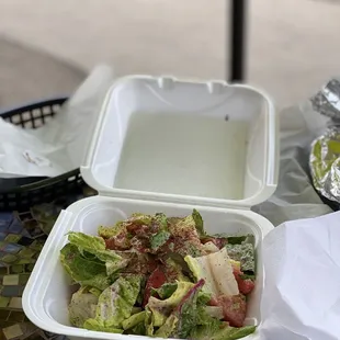 a salad in a styrofoam container