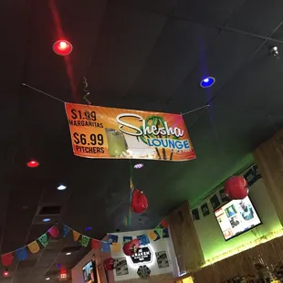 a sign hanging from the ceiling of a restaurant