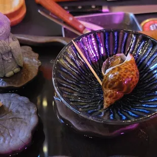 a plate of sushi and other food items