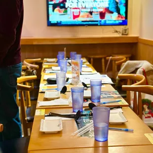 a long table with a tv in the background