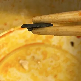 a pair of chopsticks in a pot