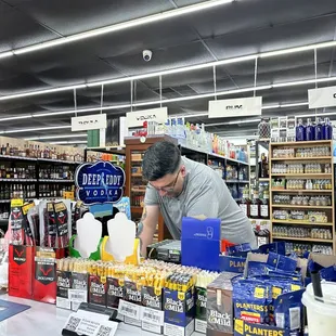 a man working at a counter in a store