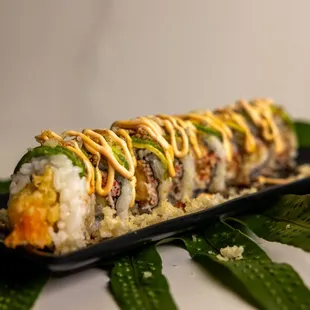 a sushi roll on a black plate