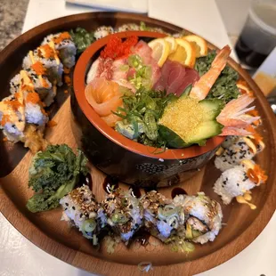 a plate of sushi and vegetables