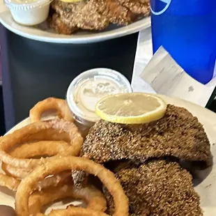 This is onion rings/fried catfish and if you notice the fish was fried in like old oil or grease! All the catfish looks like this