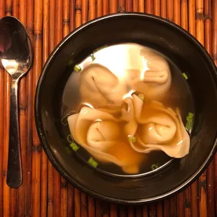 a bowl of soup with dumplings
