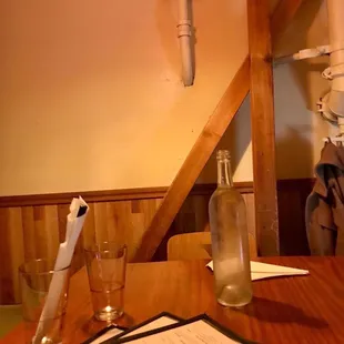 a glass of water and a menu on a table