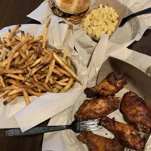 Pulled pork sandwich with green Chile Mac and cheese, basket of fries, and smoked dry rub wings