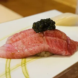 a close up of a piece of meat on a white plate