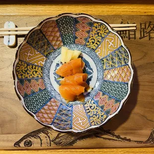 a bowl of food on a chopping board