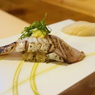 a close up of a piece of fish on a white plate