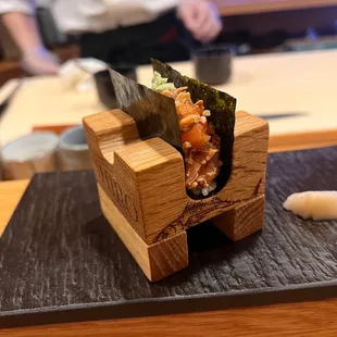 a sushi roll on a black plate