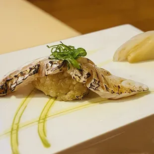 a close up of a piece of fish on a white plate