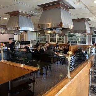 people sitting at tables in a restaurant