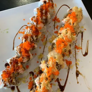 two pieces of sushi on a white plate