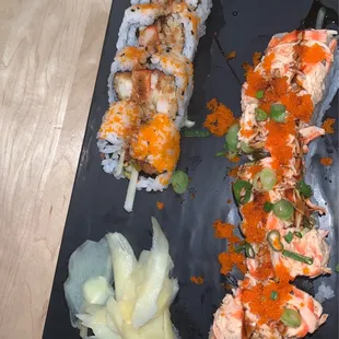 a plate of sushi and vegetables