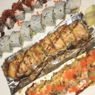 a plate of sushi and rolls