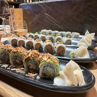 a variety of sushi rolls on plates