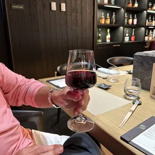 a man holding a glass of wine