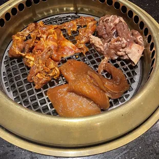 a variety of meats on a grill