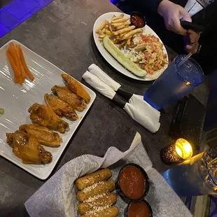 Wings, mozzarella sticks, and fried fish tacos