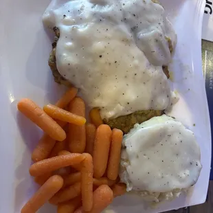 Country Fried Steak with mashed potatoes, gravy and carrots.