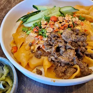 Fresh pulled noodles with sesame sauce, 5 spice ground pork, and side of pickled bittermelon, so yum!