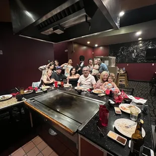 a large group of people sitting at a table