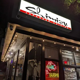 Outside. Storefront. Freestanding building. Portrait orientation. 1.0x zoom.