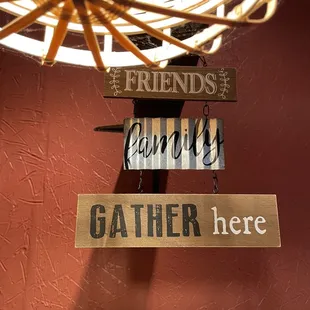 a sign that says friends family gather here